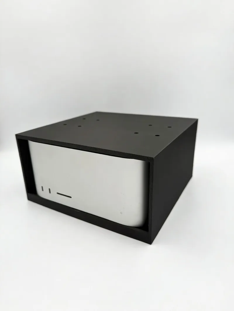 Black 3D printed under-desk cage mount holding a desktop computer