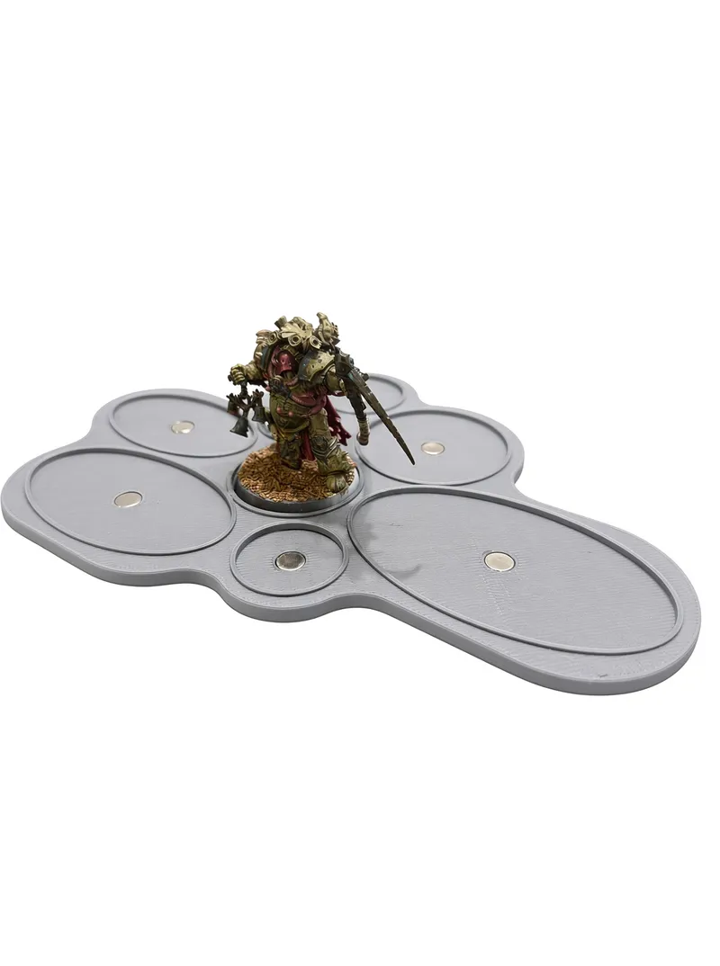 Grey 3D printed jig with recesses for eight base sizes and embedded magnets