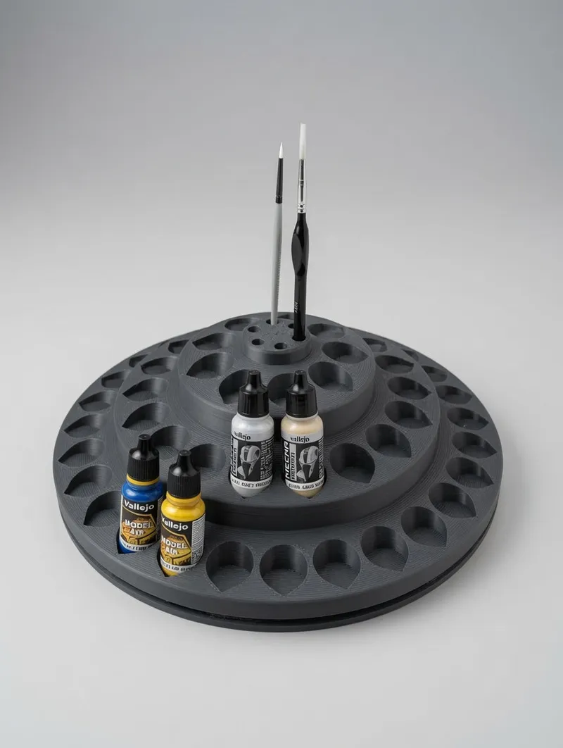 Rotating Paint Carousel 57 with dropper bottles and two brushes in the centre