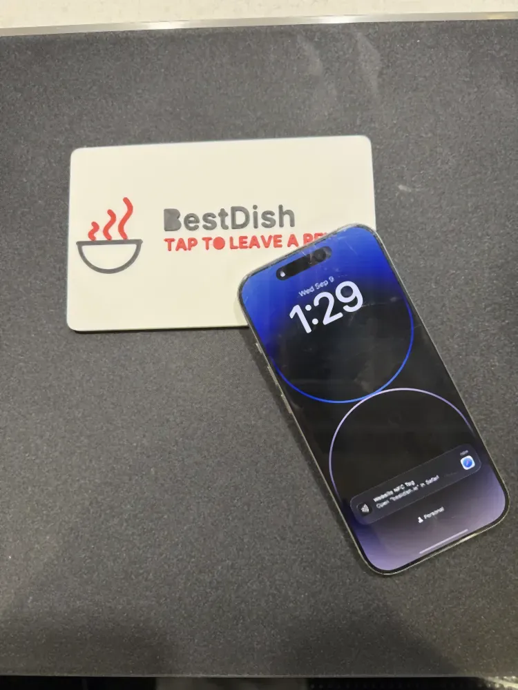 3D printed NFC review plaque with a logo, a phone tapping it to open a review page