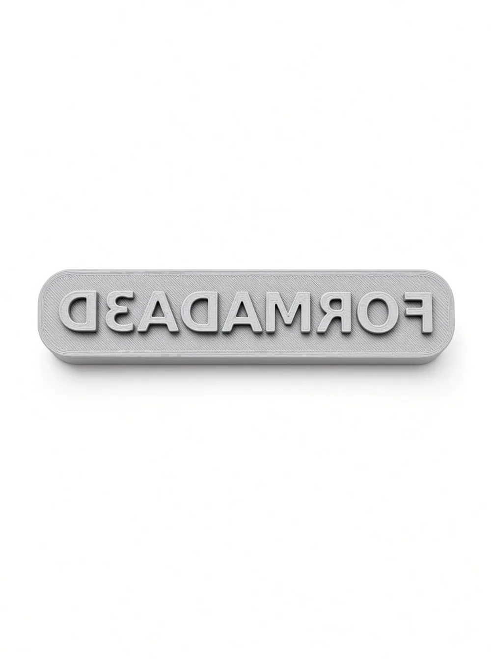 Custom text stamp printed from Stamp Maker, mirrored FORMADA3D lettering, close-up