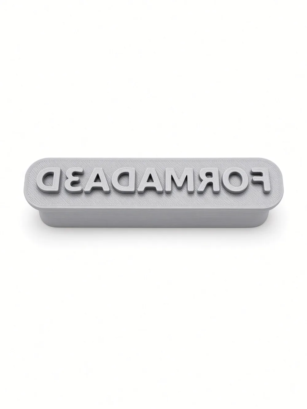 Custom text stamp printed from Stamp Maker, mirrored lettering, top view