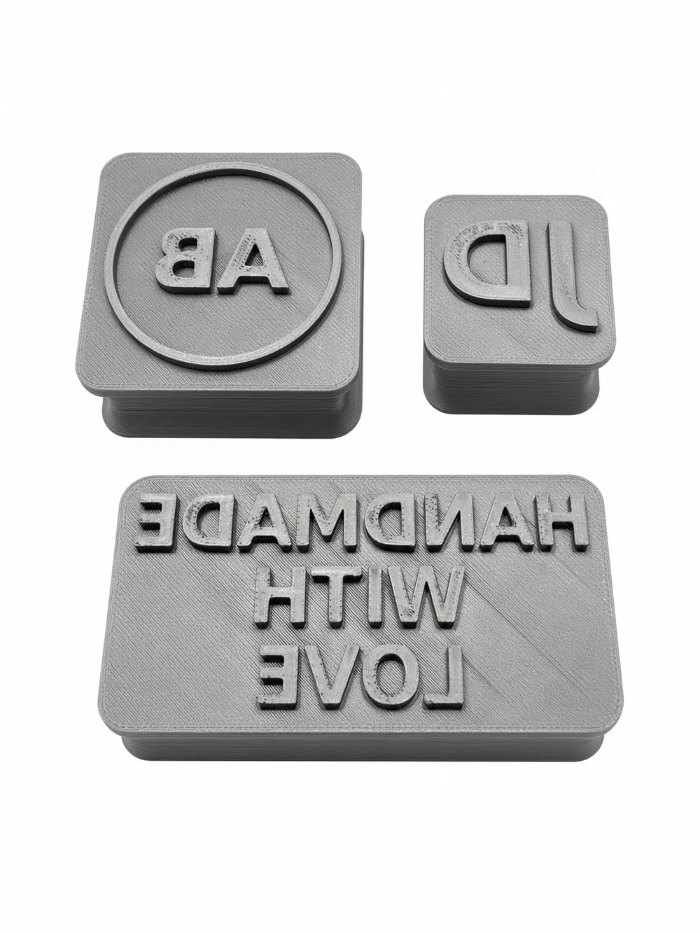 Three printed custom text stamps from Stamp Maker, top view on white