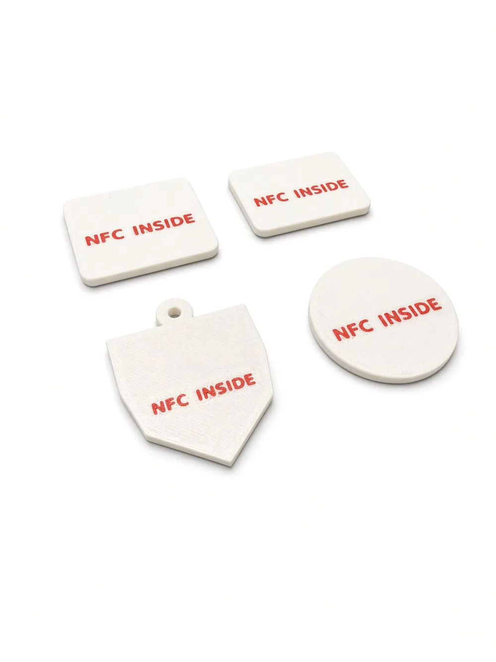 Backs of the NFC tags with the red NFC INSIDE mark over the sealed chip, angled